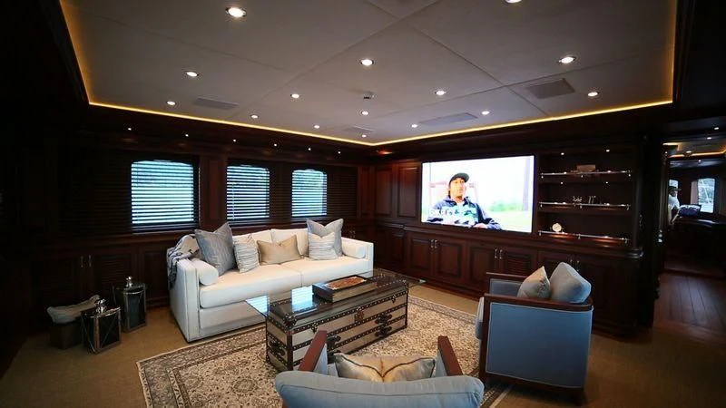 a living room with a large tv aboard OMNIA 1 Yacht for Sale