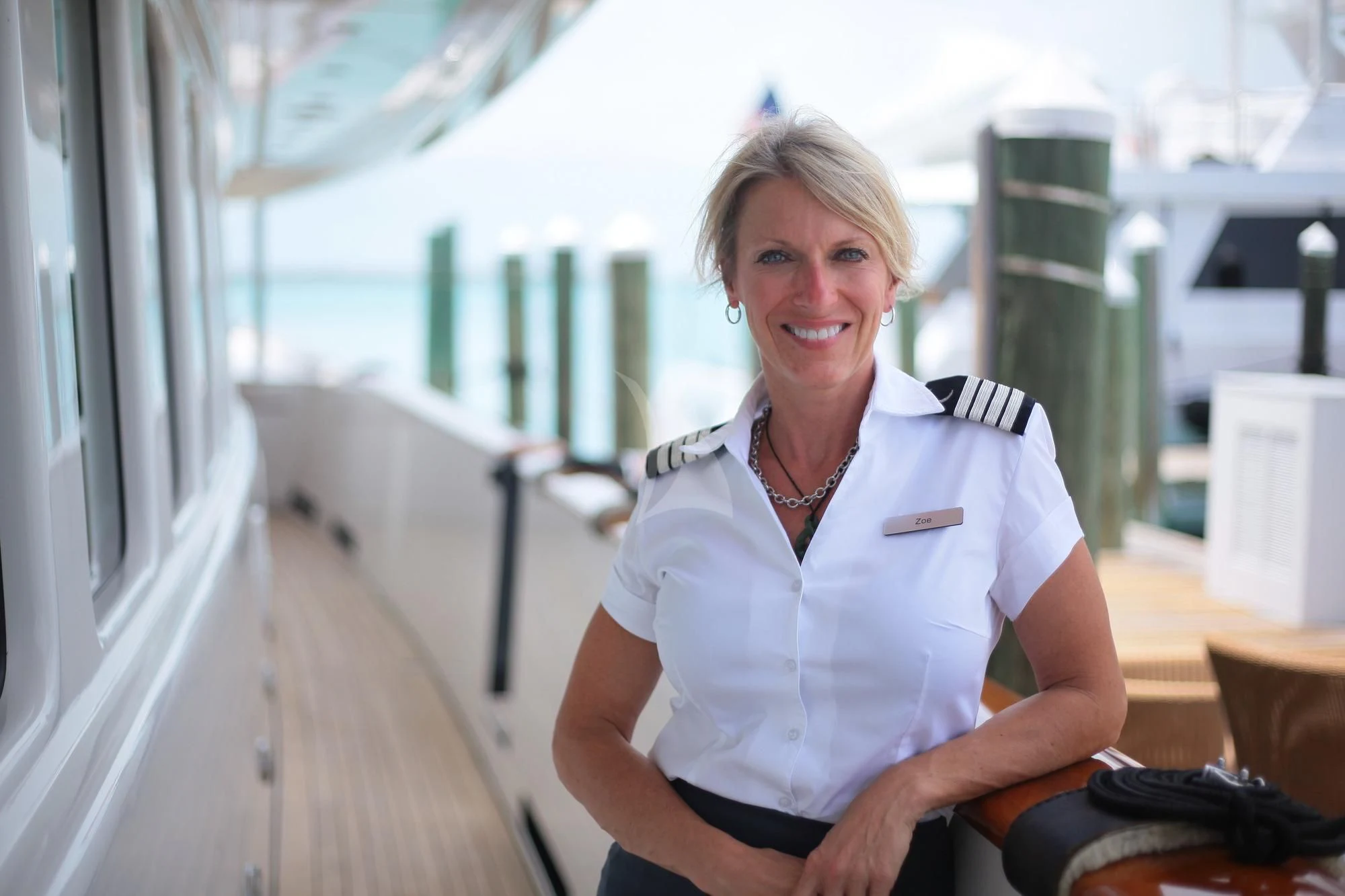 a woman sitting in a chair aboard OMNIA 1 Yacht for Sale