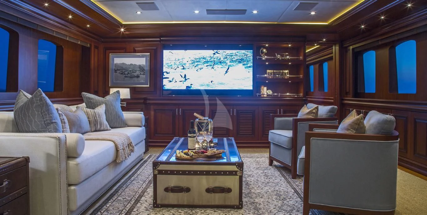a living room with a couch and a coffee table aboard OMNIA 1 Yacht for Sale