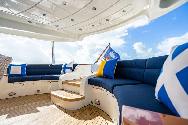a room with a blue couch and a white and yellow pillow aboard OMNIA 1 Yacht for Sale