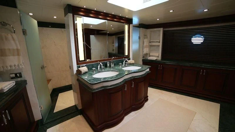 a bathroom with a large mirror aboard OMNIA 1 Yacht for Sale
