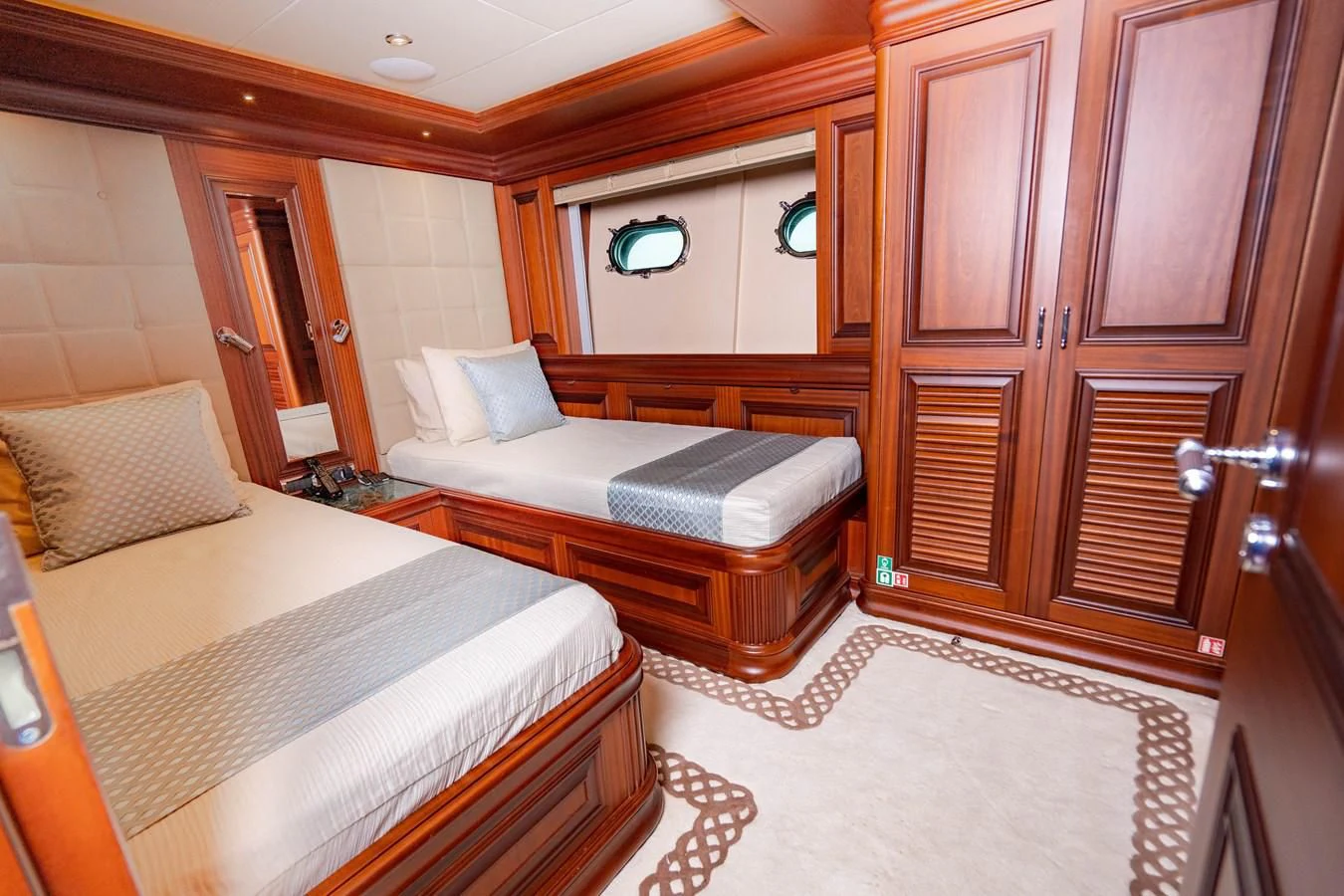 a hotel room with two beds aboard OMNIA 1 Yacht for Sale