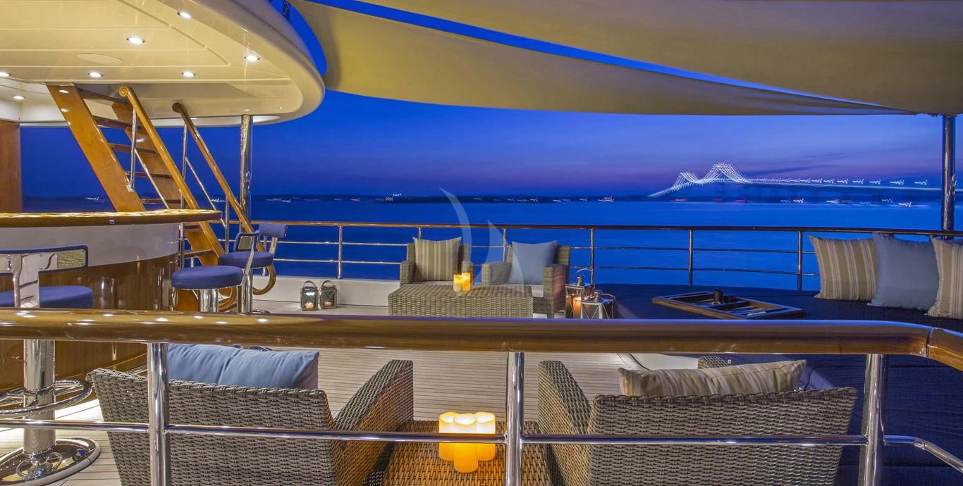 a pool with chairs and a table aboard OMNIA 1 Yacht for Sale