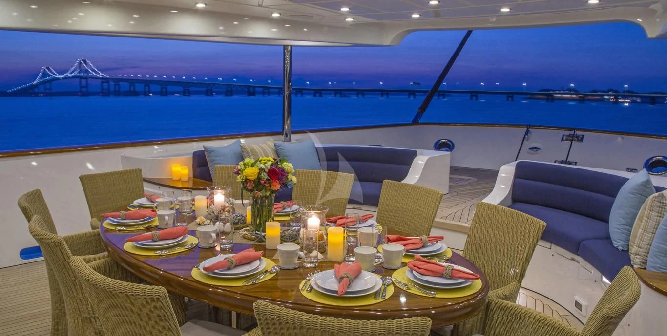 a table set with candles and flowers aboard OMNIA 1 Yacht for Sale