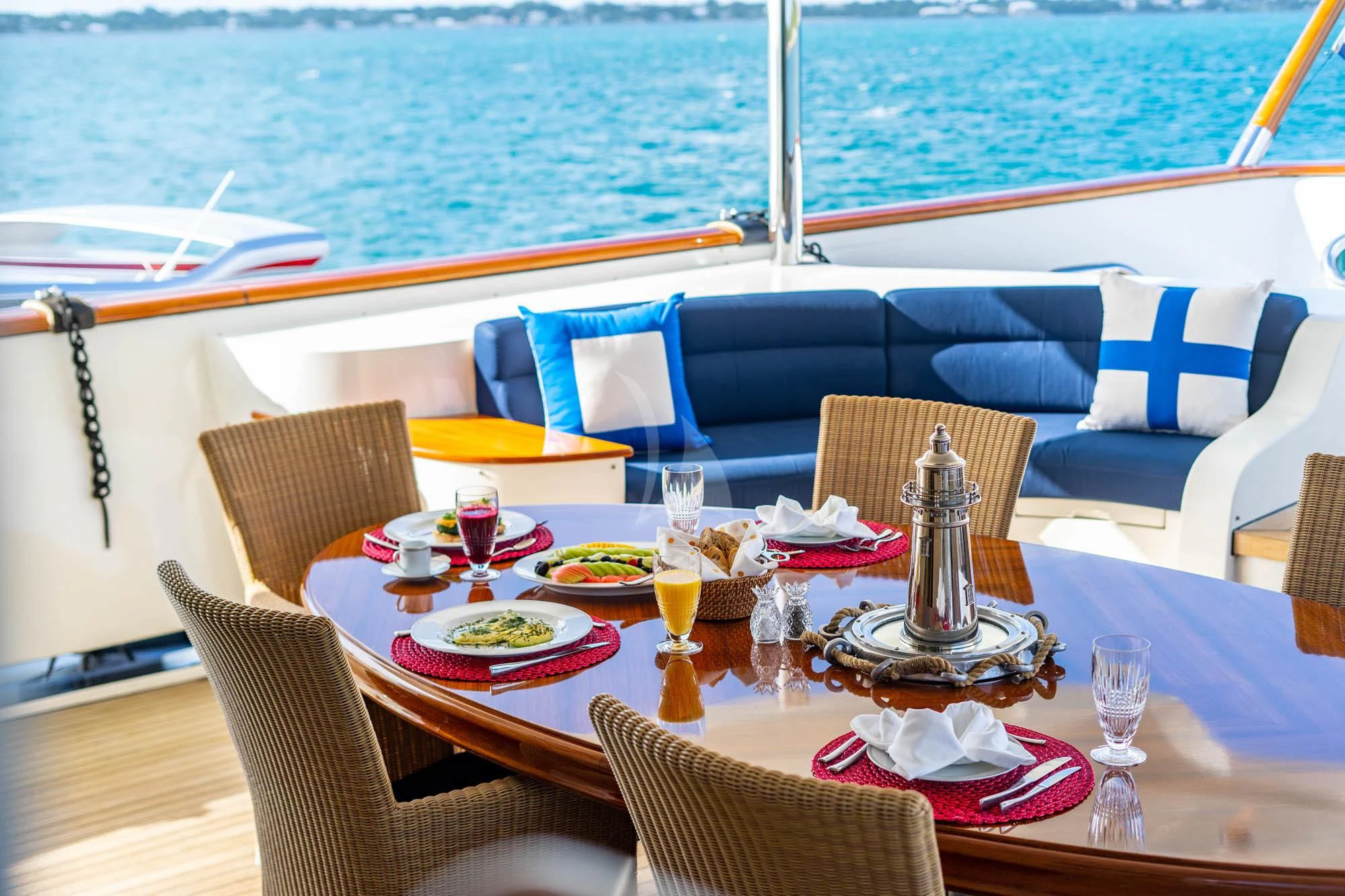 a table set for a meal on a boat aboard OMNIA 1 Yacht for Sale
