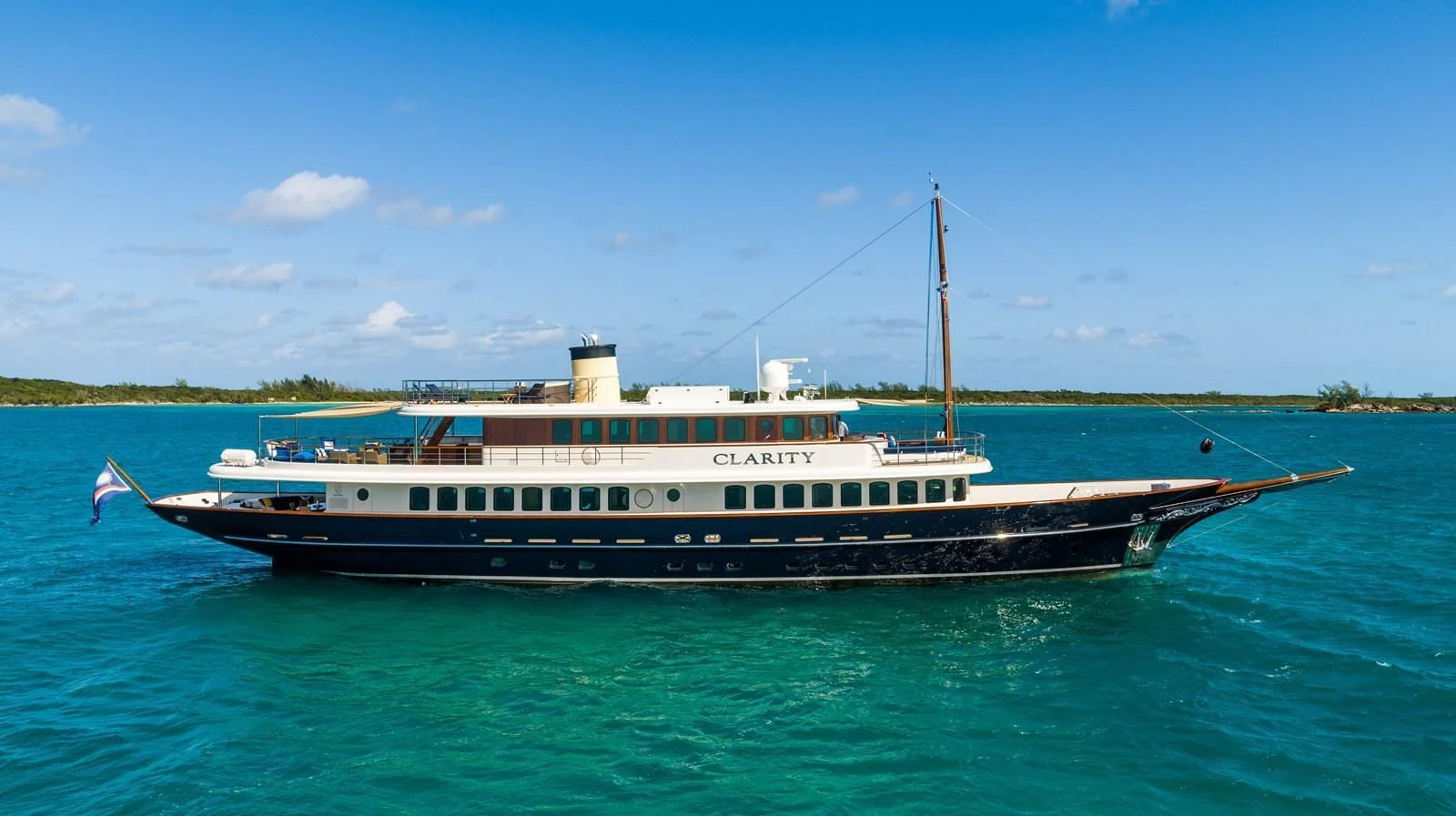 a large boat on the water aboard OMNIA 1 Yacht for Sale