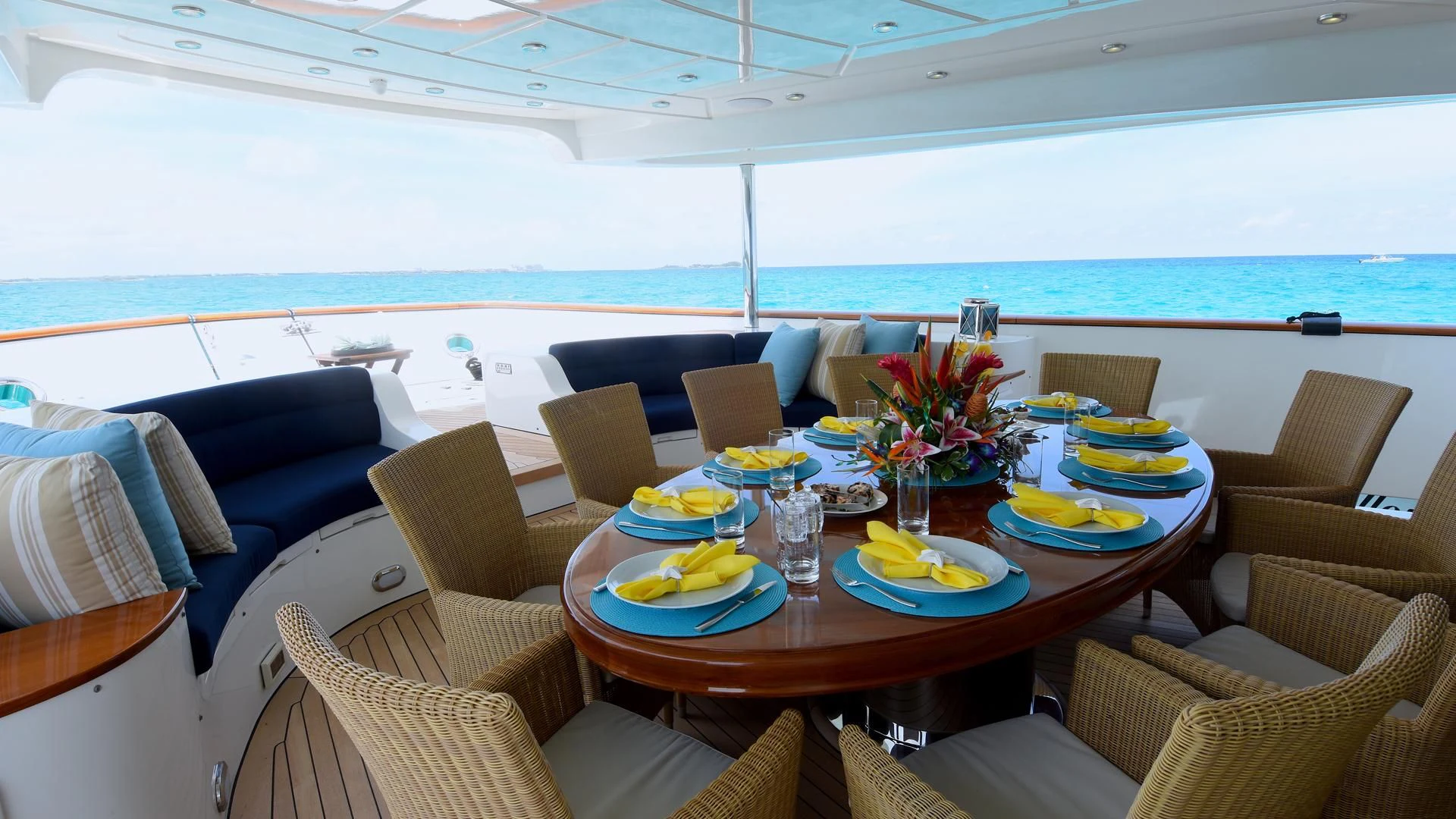a table with plates and food on it aboard OMNIA 1 Yacht for Sale