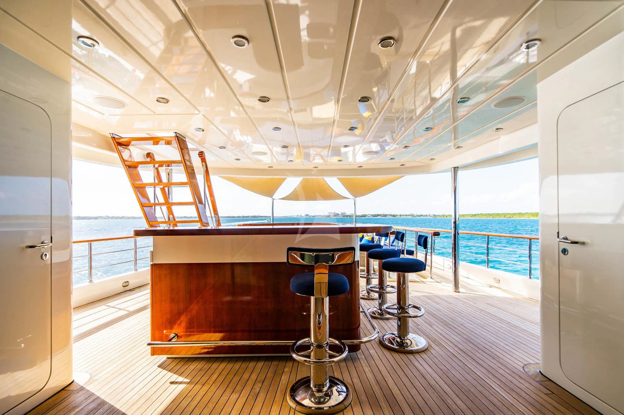 a room with a table and stools and a window aboard OMNIA 1 Yacht for Sale