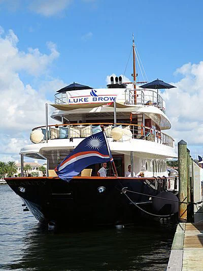 a boat with a flag on it aboard OMNIA 1 Yacht for Sale