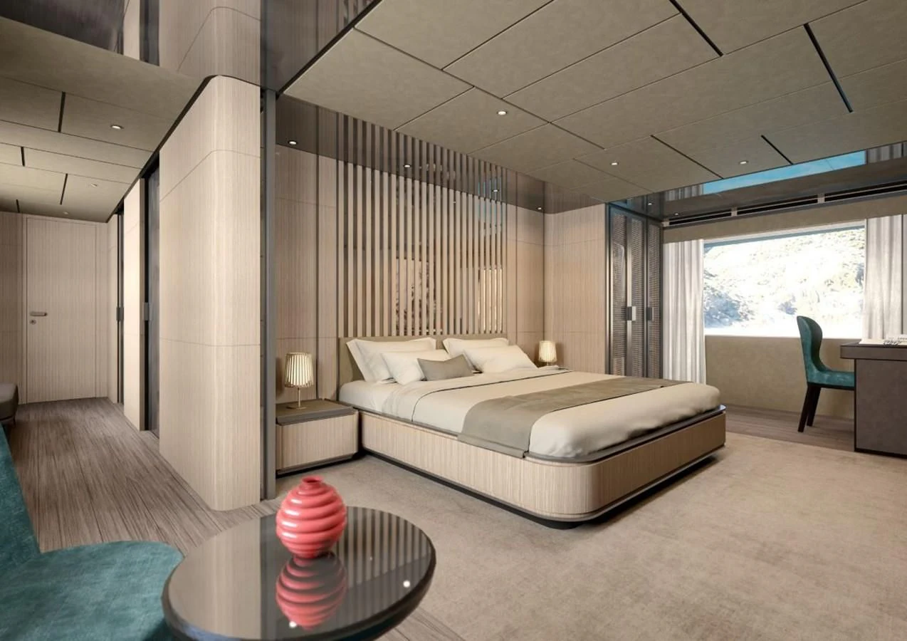a bedroom with a bed and a chair aboard HORIZON Yacht for Sale