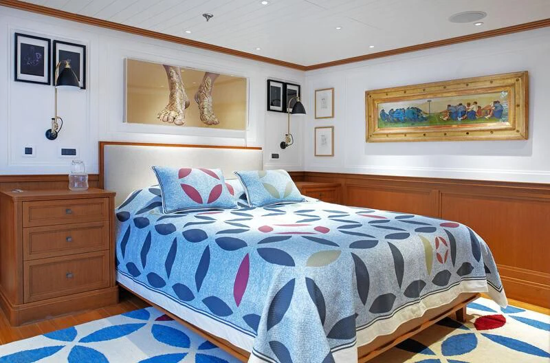 a bed with a blue comforter aboard MESERRET II Yacht for Sale