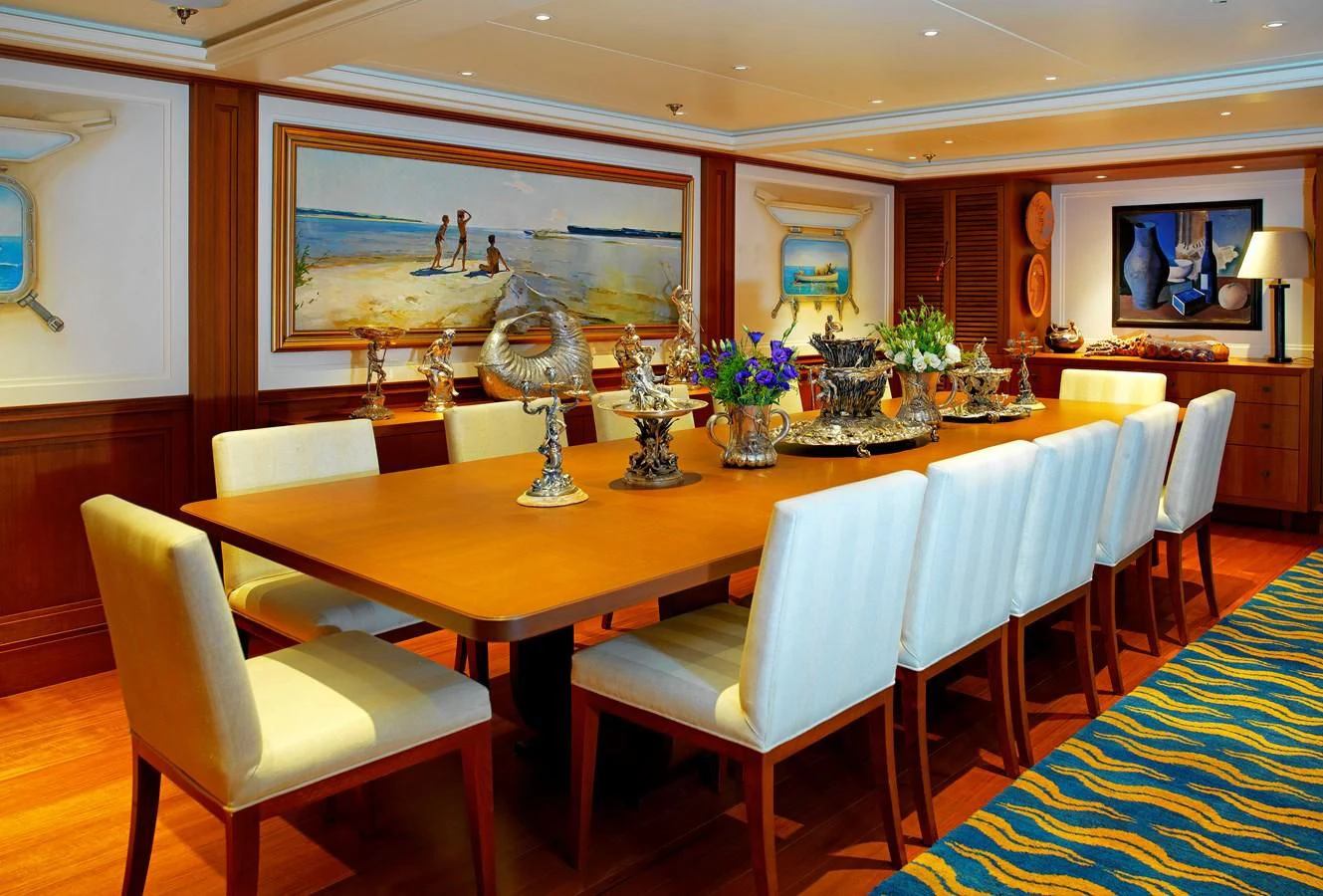 a dining room with a table and chairs aboard MESERRET II Yacht for Sale
