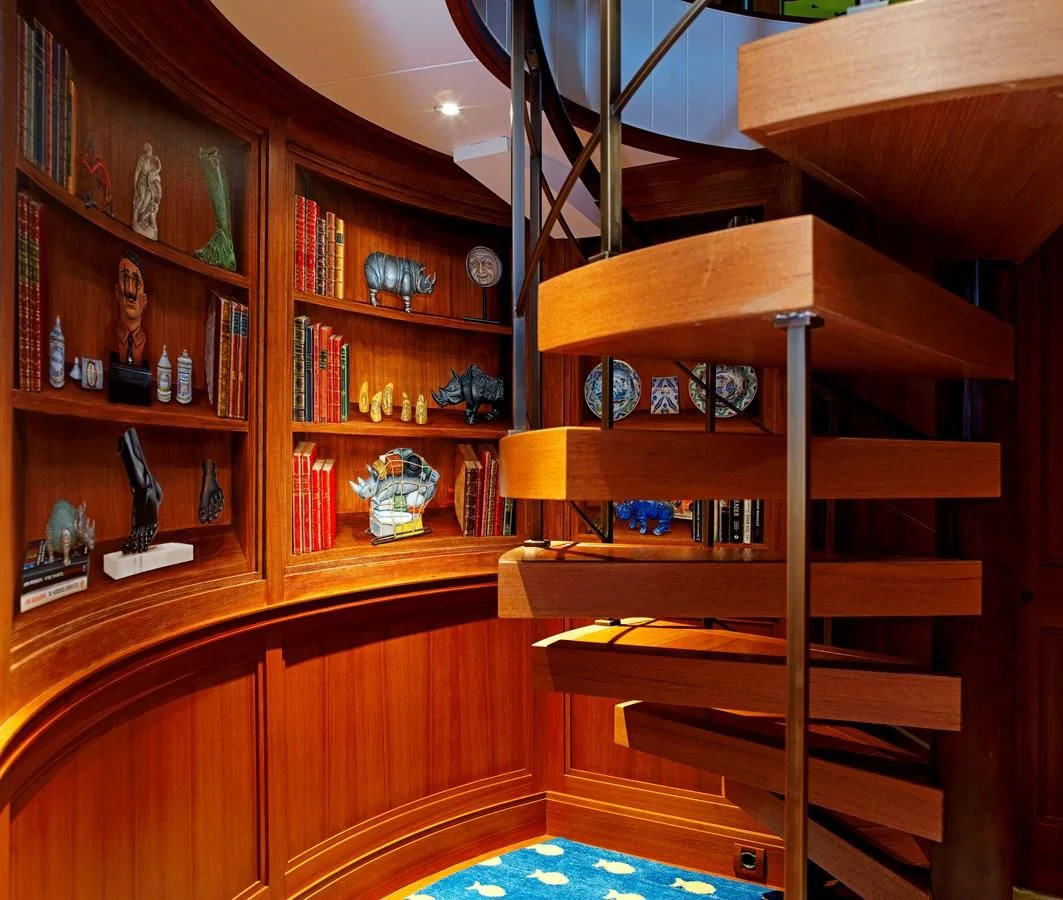 a bookshelf with books and knick knacks aboard MESERRET II Yacht for Sale