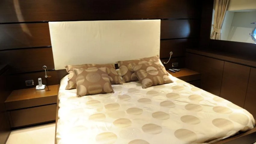 a bed with a white comforter aboard ANDEA Yacht for Sale