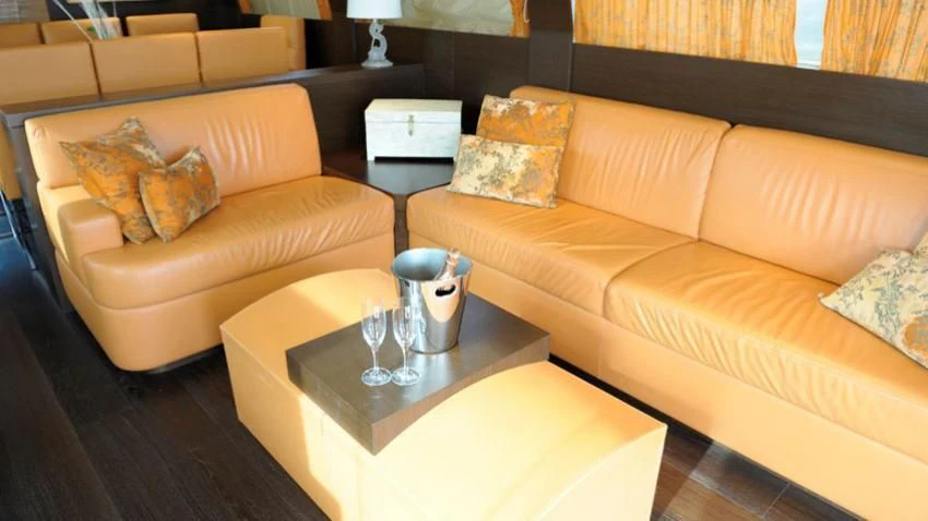 a coffee table with a glass on it aboard ANDEA Yacht for Sale