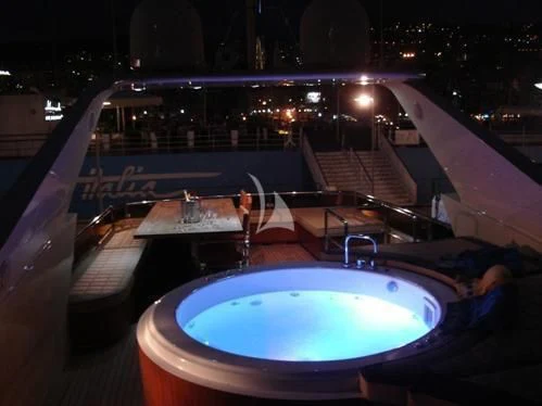 a large pool with a large round table and chairs aboard ANDEA Yacht for Sale