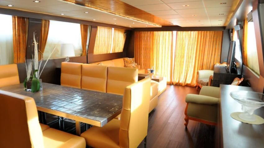 a living room with a table and chairs aboard ANDEA Yacht for Sale