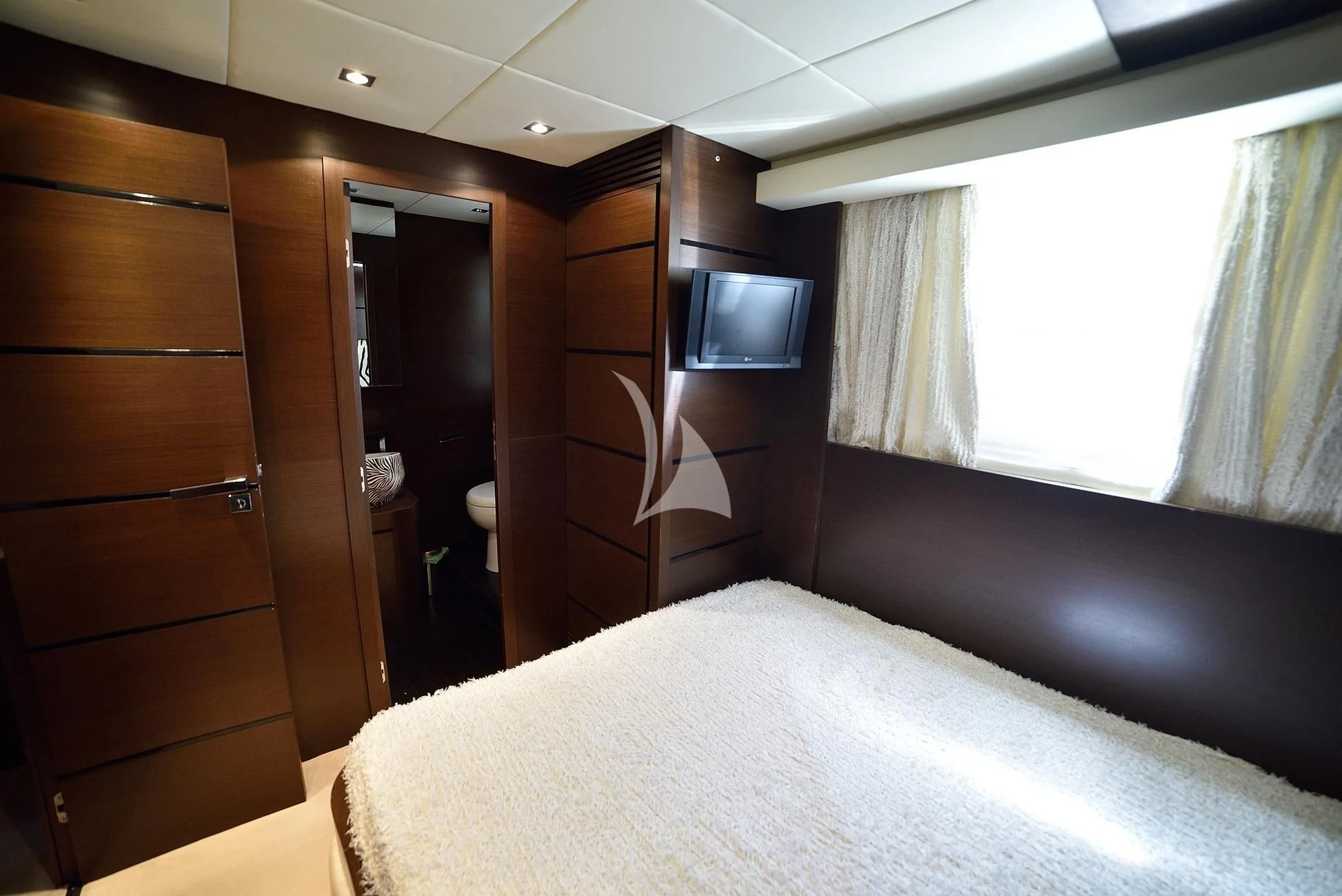 a room with a bed and a television aboard ANDEA Yacht for Sale