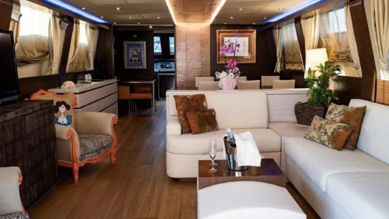 a living room with a couch and a television aboard ANDEA Yacht for Sale