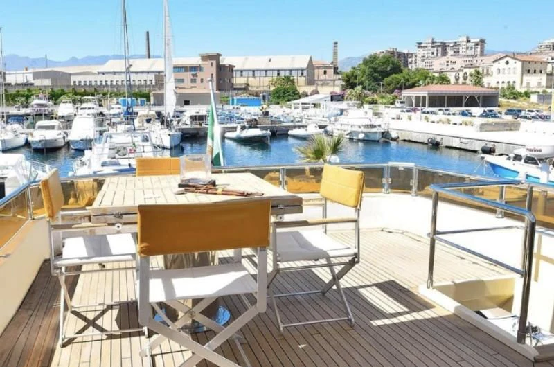 a group of chairs on a deck overlooking a marina aboard ANDEA Yacht for Sale