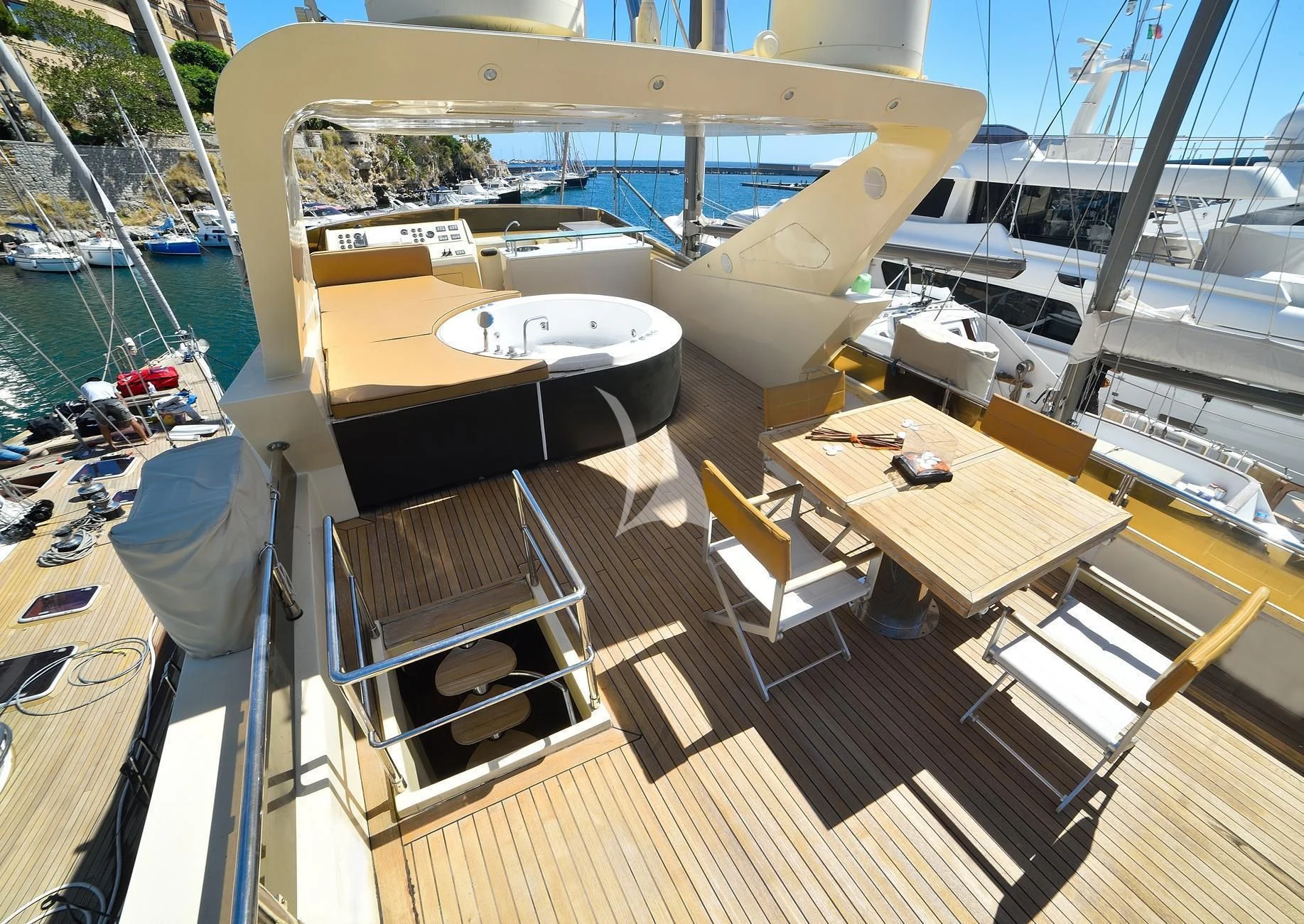 a deck with a boat and a table on it aboard ANDEA Yacht for Sale