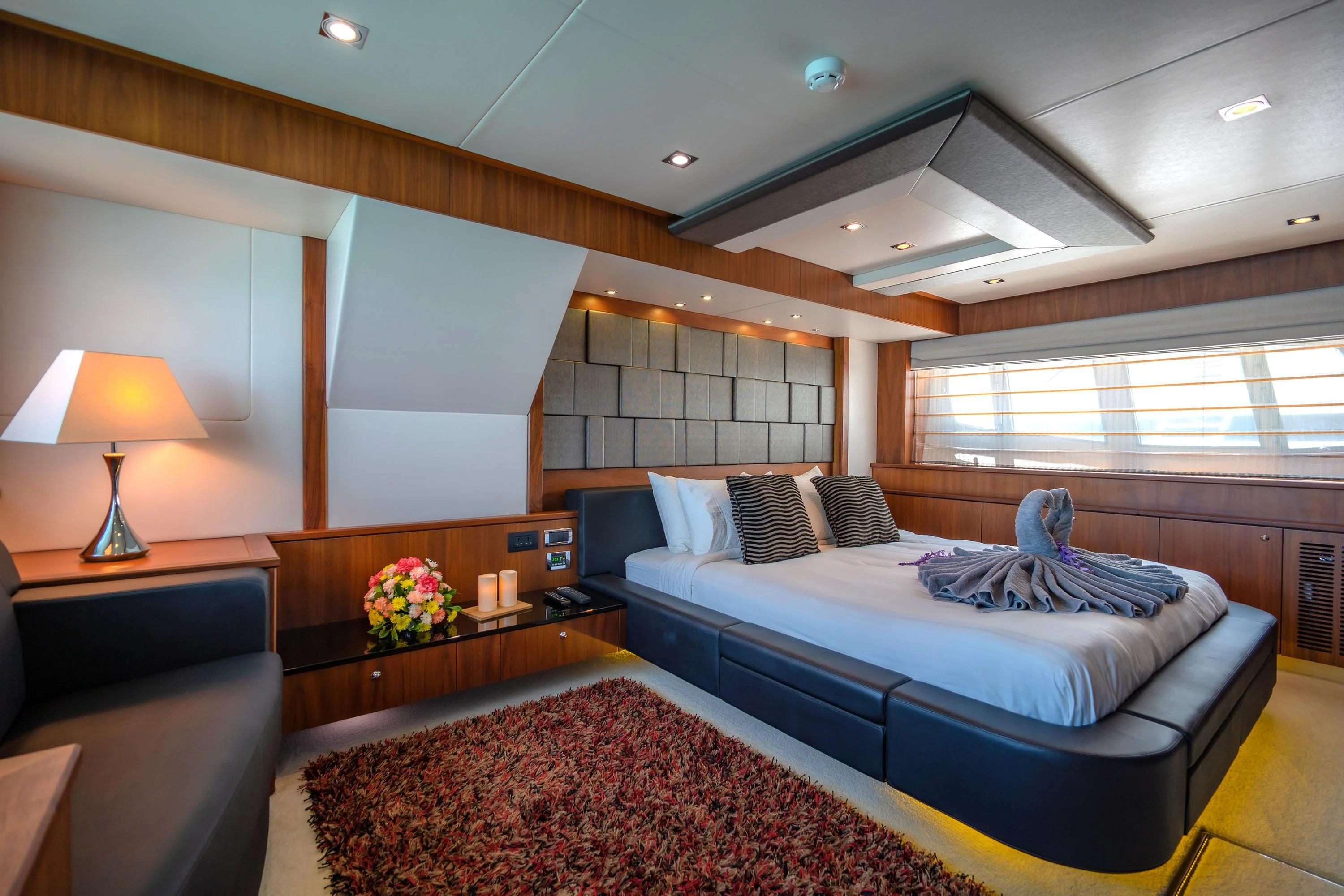 a bedroom with a bed and a table aboard ANDEA Yacht for Sale