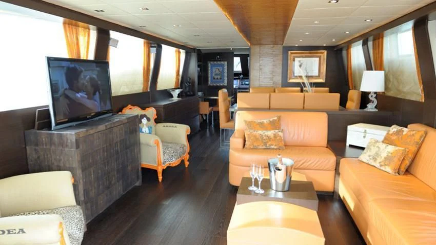 a living room with a tv and furniture aboard ANDEA Yacht for Sale