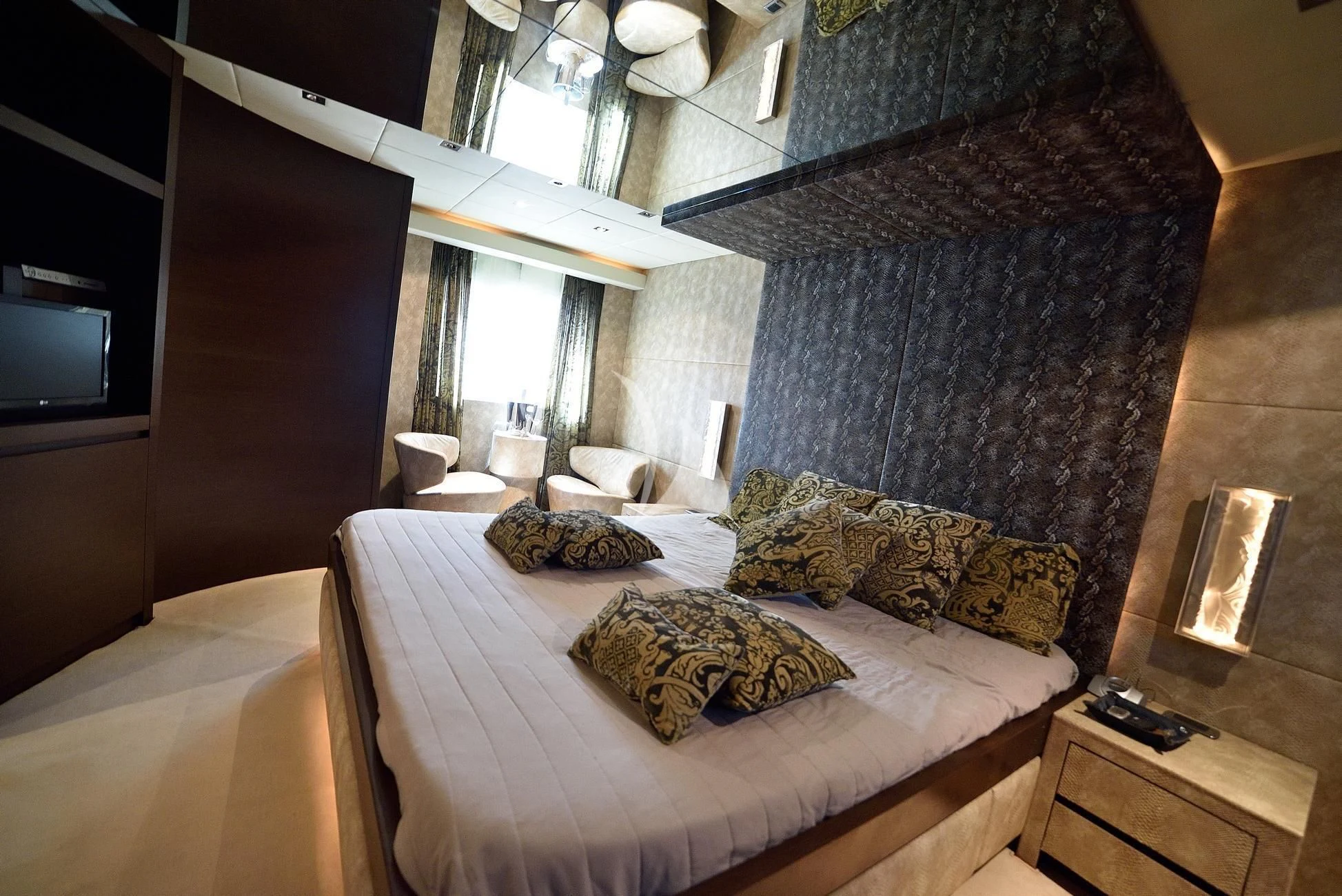 a bedroom with a bed and a television aboard ANDEA Yacht for Sale