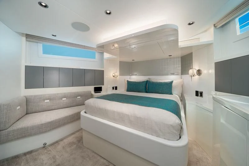a room with a bed and a couch aboard RING-N-WET Yacht for Sale
