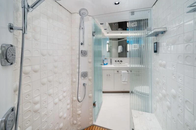 a room with white tile walls aboard RING-N-WET Yacht for Sale