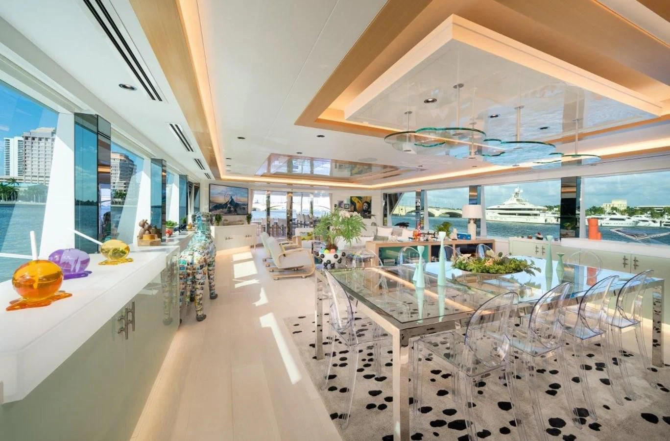 a room with tables chairs and a large window aboard RING-N-WET Yacht for Sale