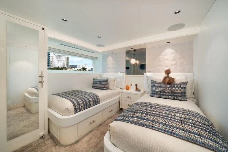a bedroom with two beds aboard RING-N-WET Yacht for Sale