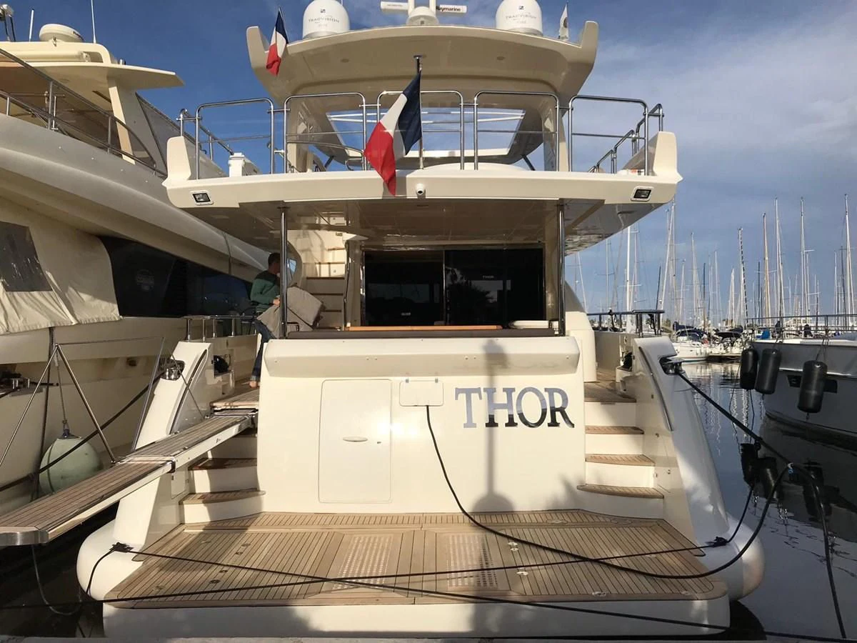 a boat with flags on it aboard THOR Yacht for Sale