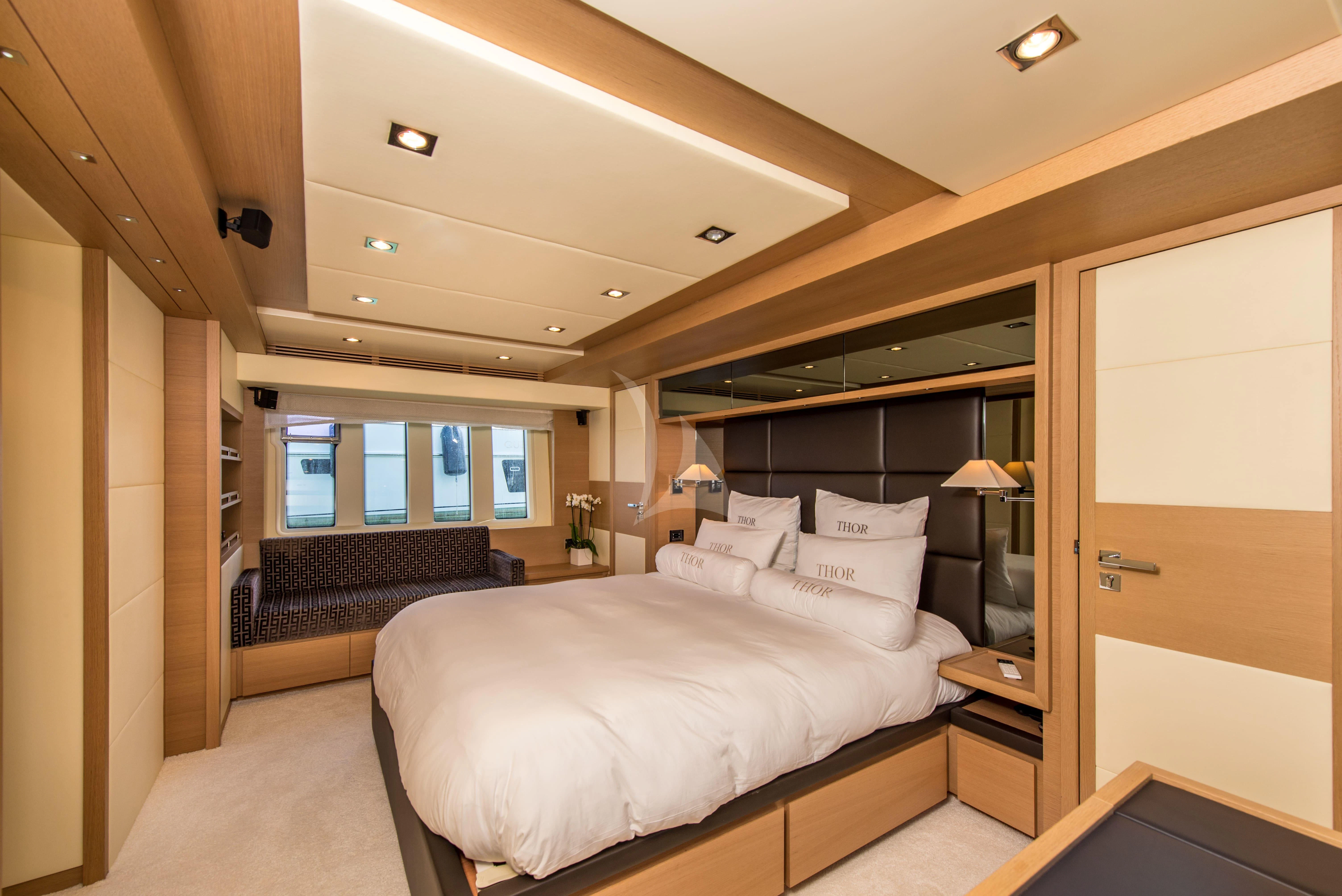 a bedroom with a large bed aboard THOR Yacht for Sale