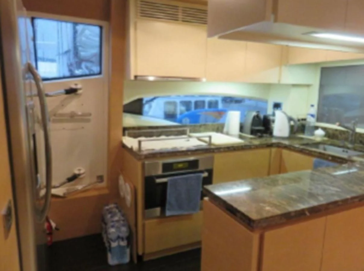 a kitchen with a sink and a refrigerator aboard THOR Yacht for Sale