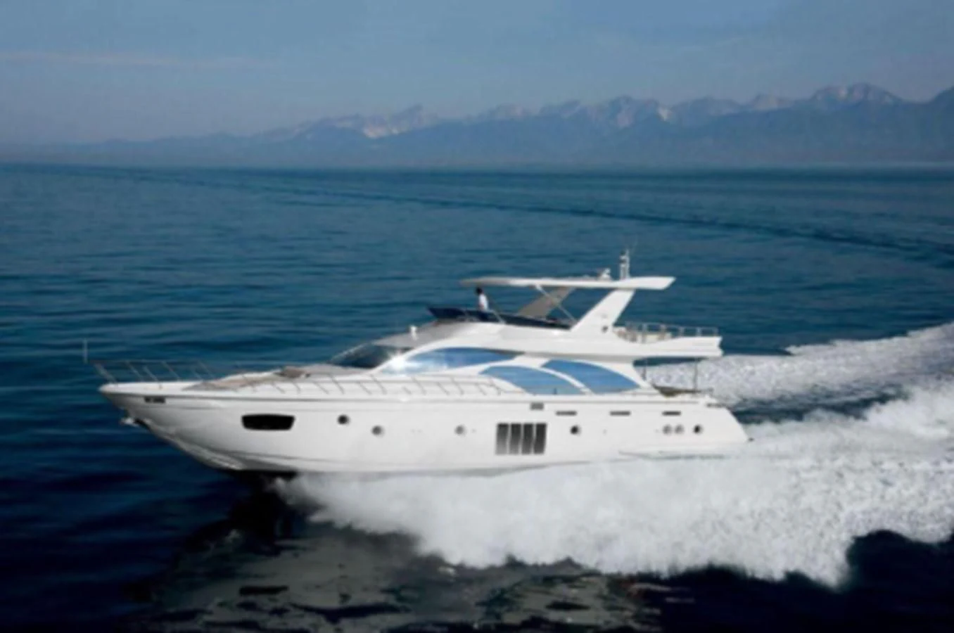 a white yacht on the water aboard THOR Yacht for Sale