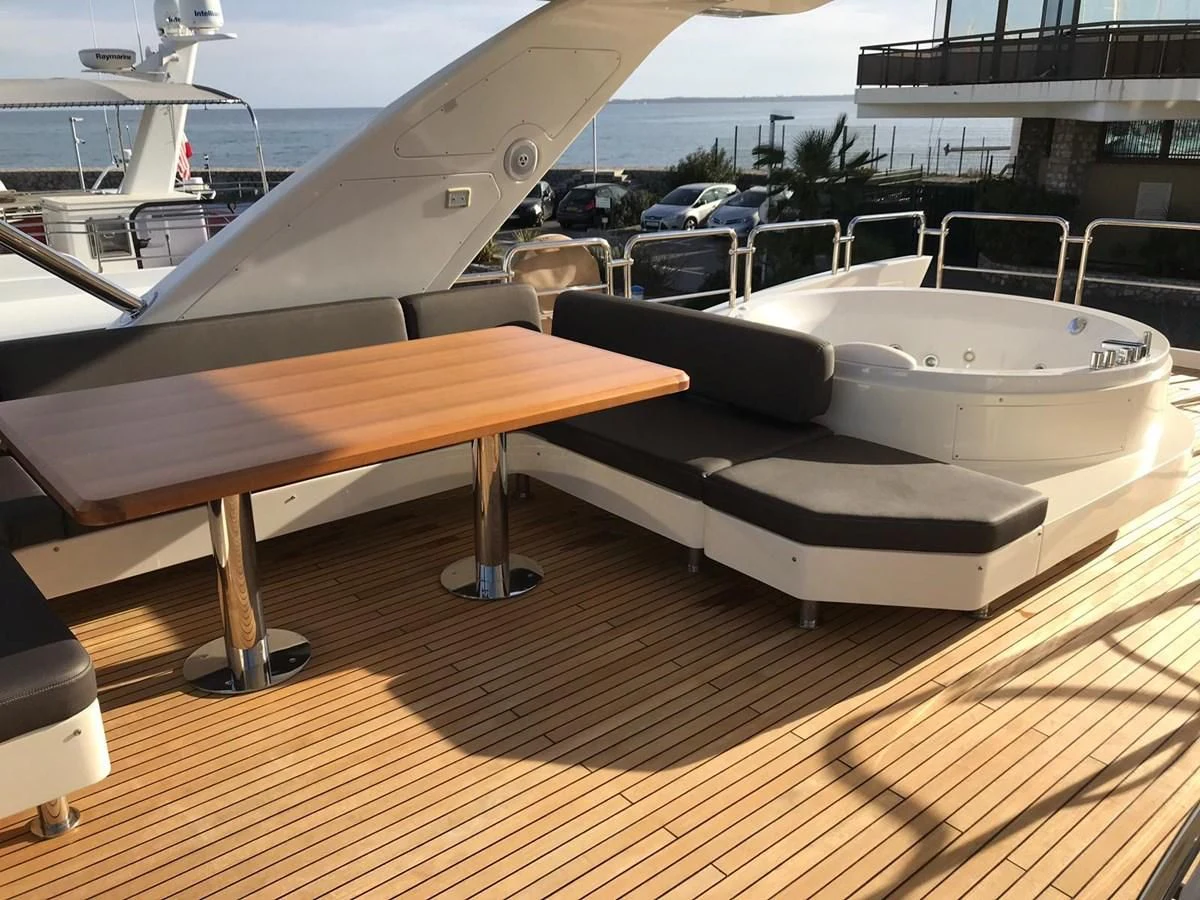 a wooden table with a white boat on it aboard THOR Yacht for Sale