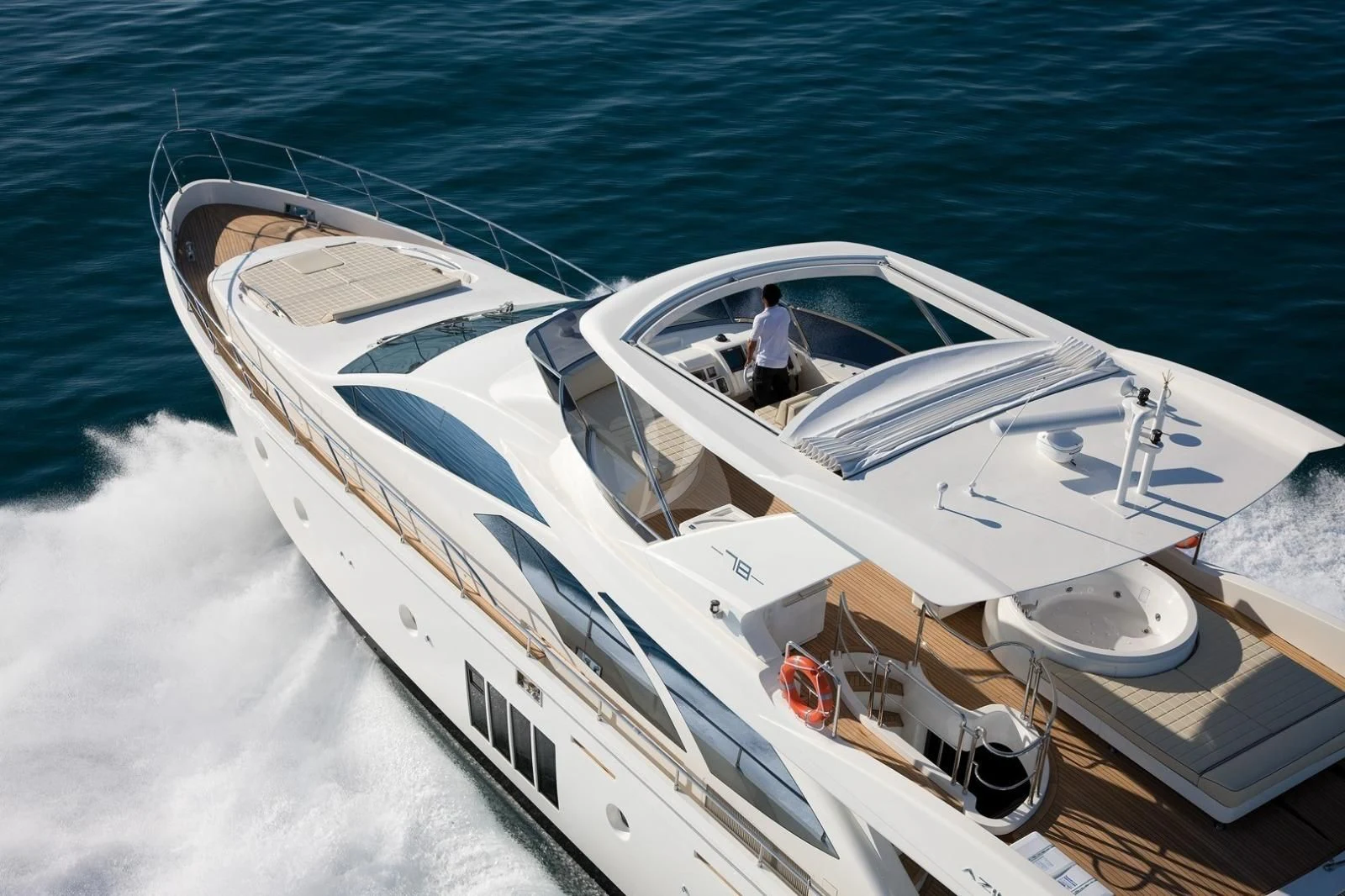 a person driving a boat on the water aboard THOR Yacht for Sale