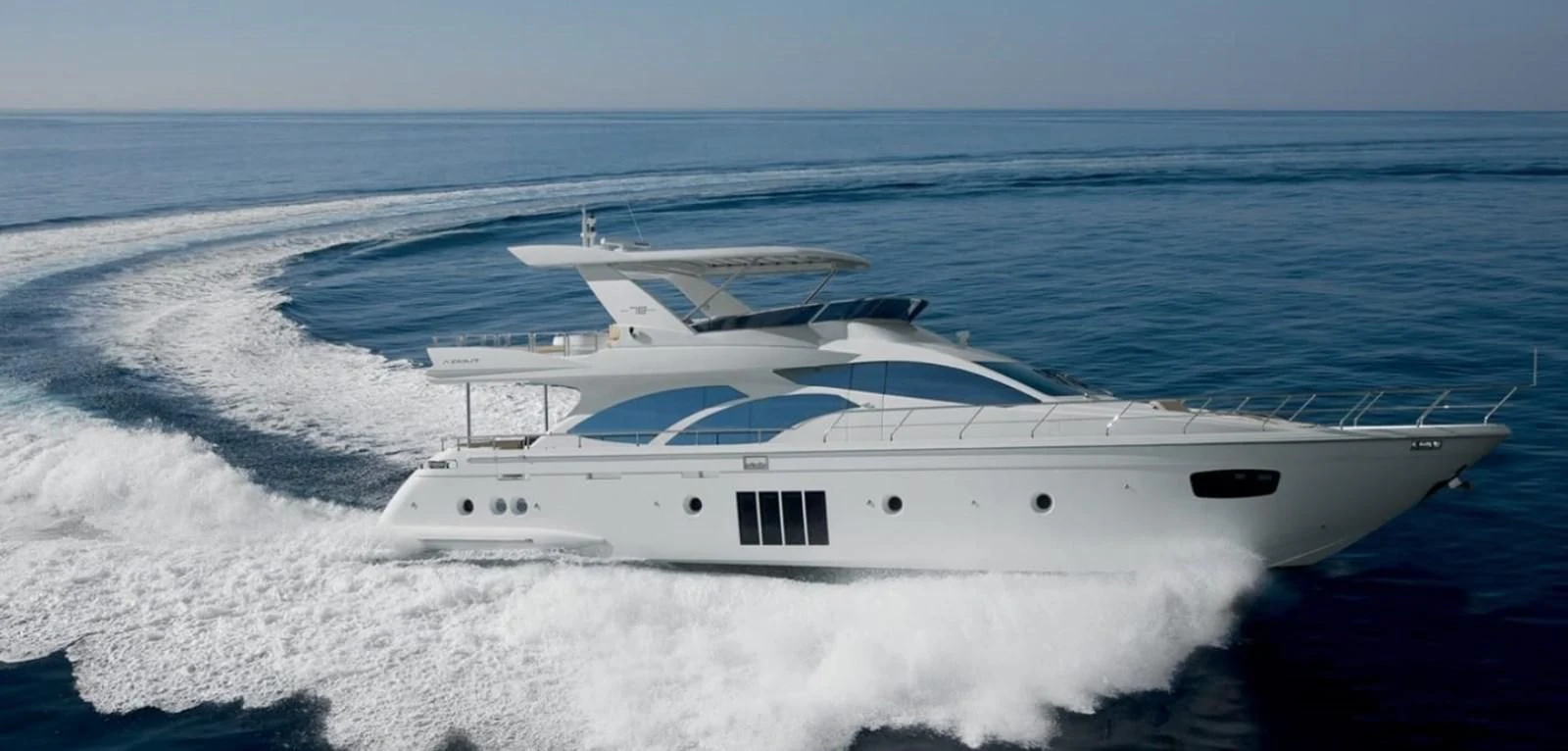 a white yacht on the water aboard THOR Yacht for Sale