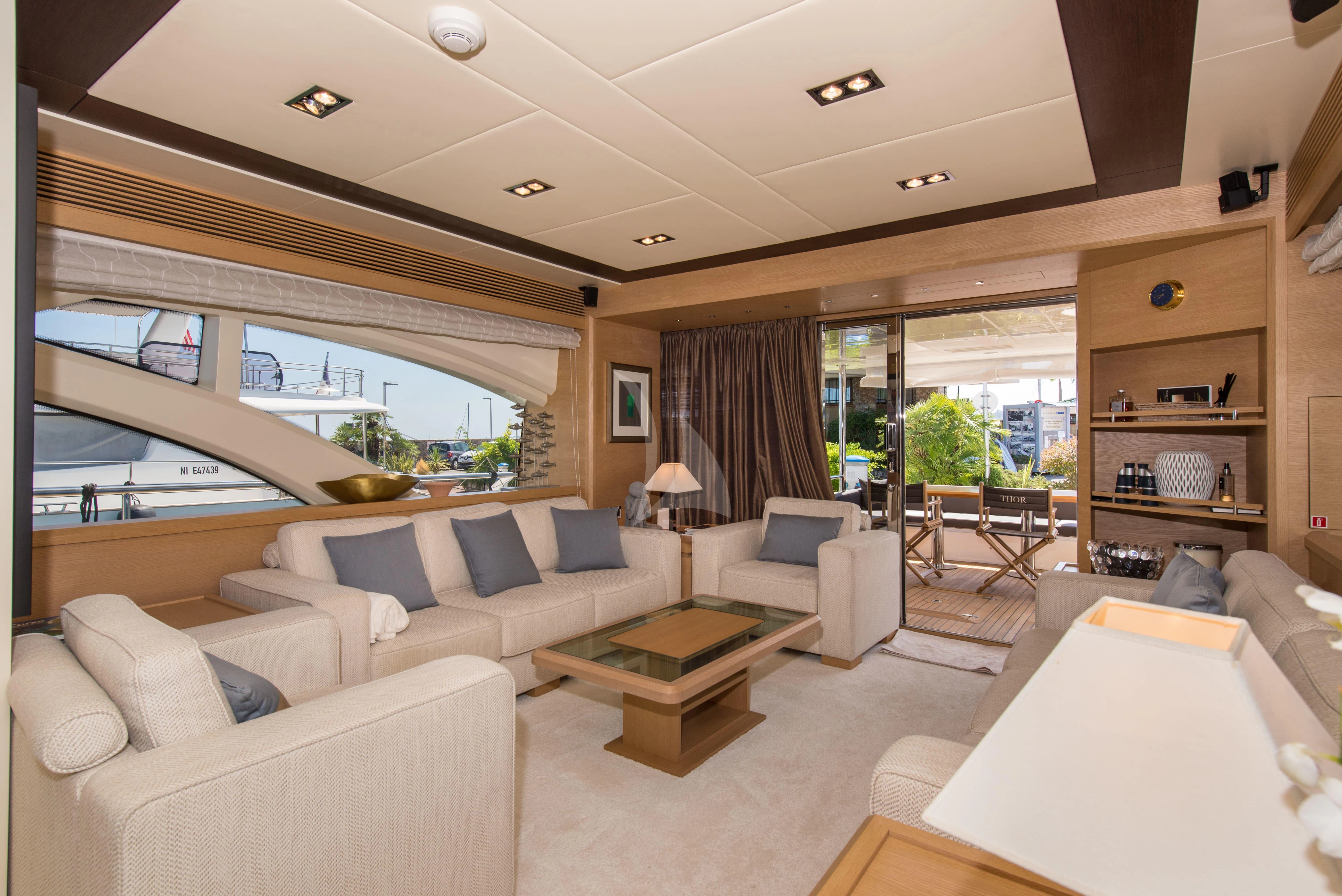 a living room with a large window aboard THOR Yacht for Sale