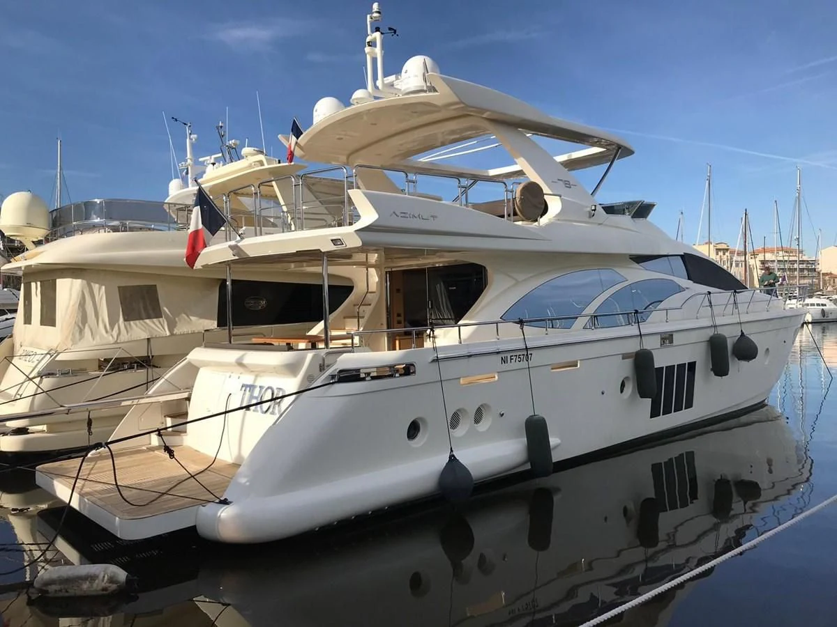 a white yacht in the water aboard THOR Yacht for Sale
