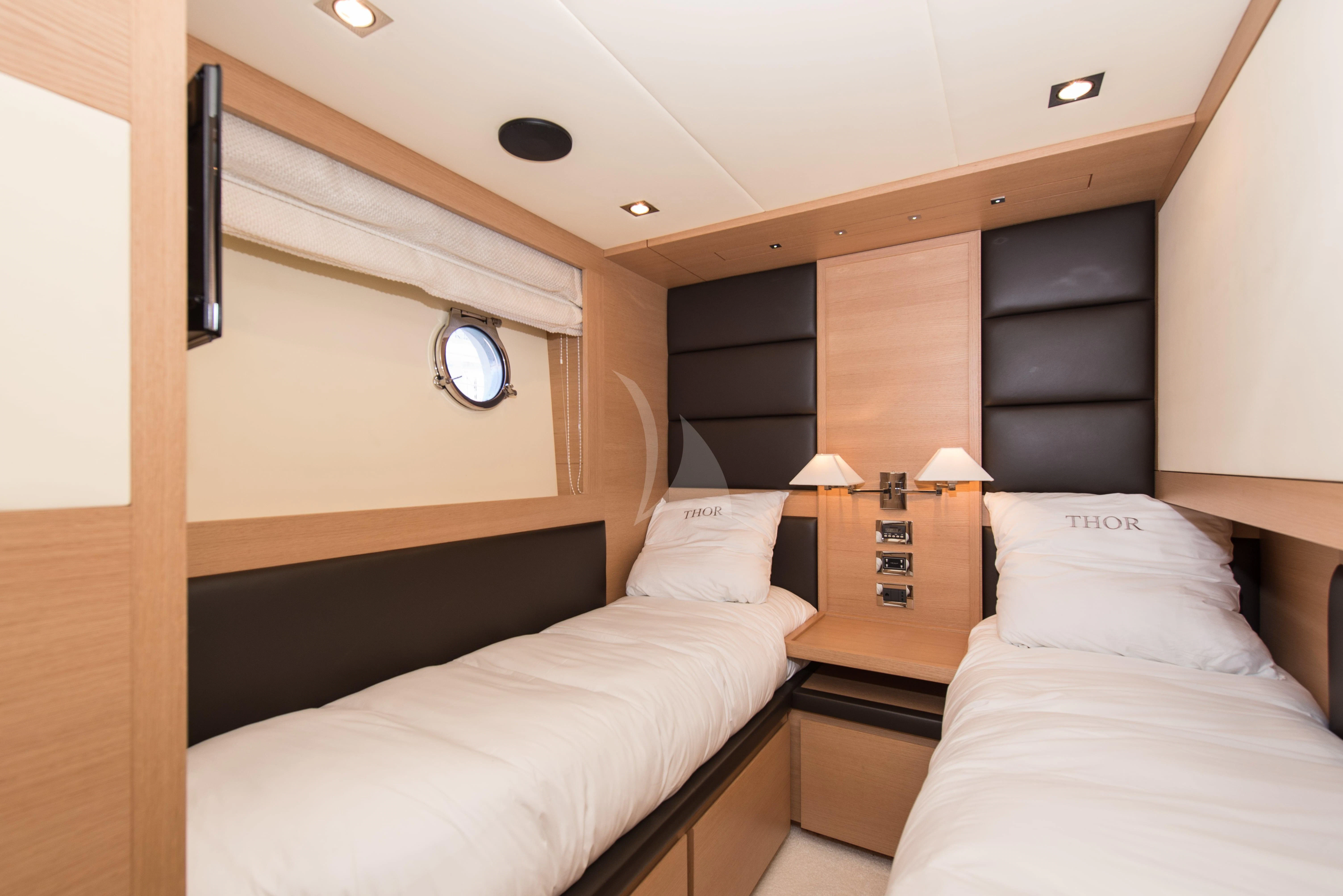 a room with two beds aboard THOR Yacht for Sale
