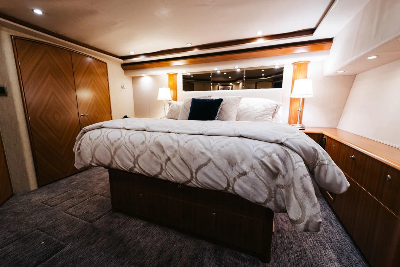 a bed with a white comforter aboard RHINO FISH Yacht for Sale