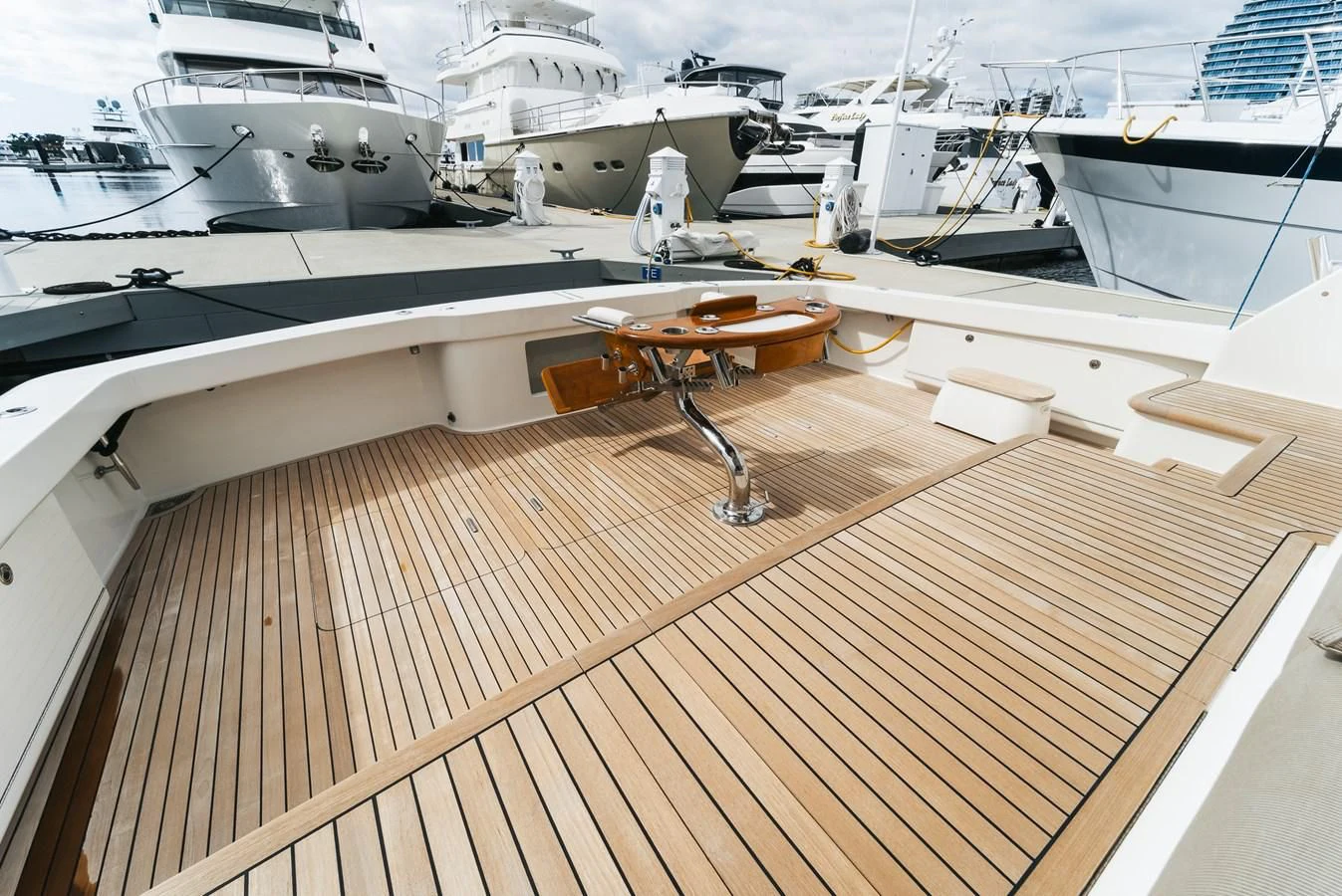 a deck with a table and chairs aboard RHINO FISH Yacht for Sale