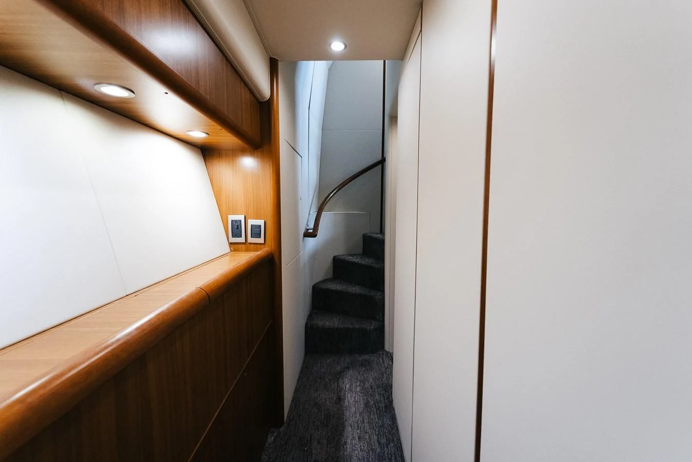 a hallway with a staircase and a carpet aboard RHINO FISH Yacht for Sale