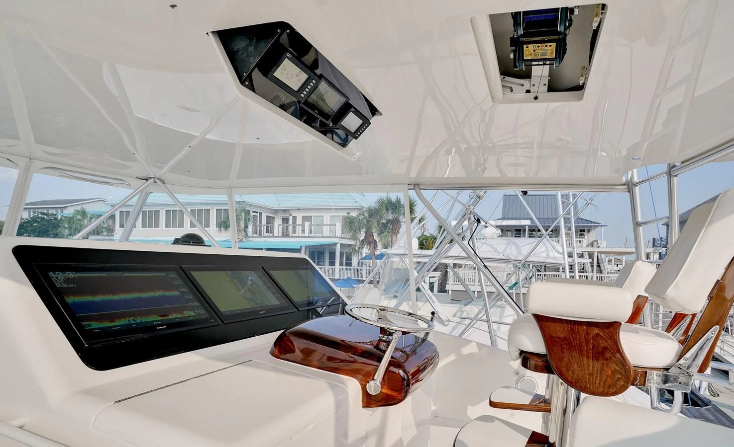 a room with a large screen and a table with chairs and a computer screen on it aboard RHINO FISH Yacht for Sale