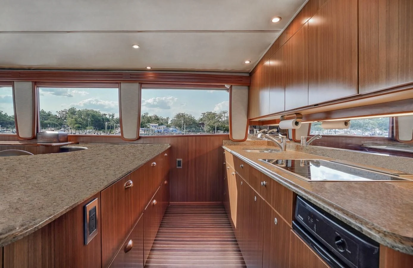 a kitchen with wooden cabinets aboard RHINO FISH Yacht for Sale