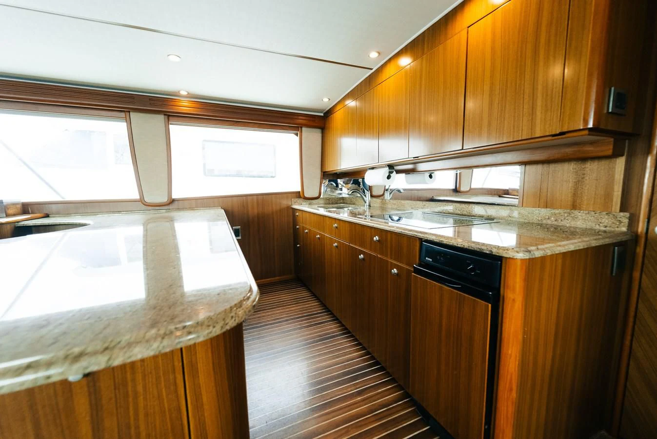 a kitchen with wooden cabinets aboard RHINO FISH Yacht for Sale