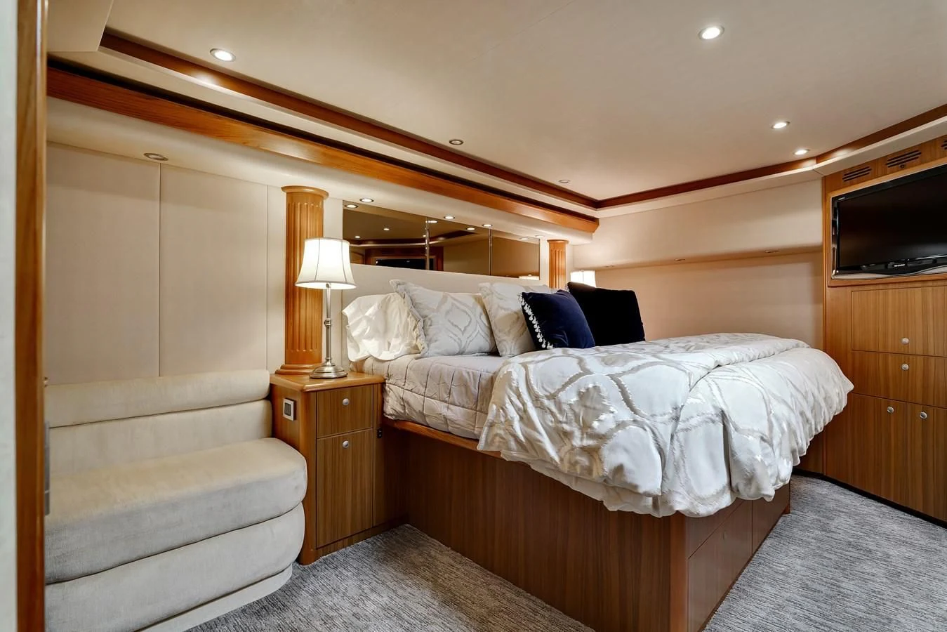 a bedroom with a bed and a television aboard RHINO FISH Yacht for Sale