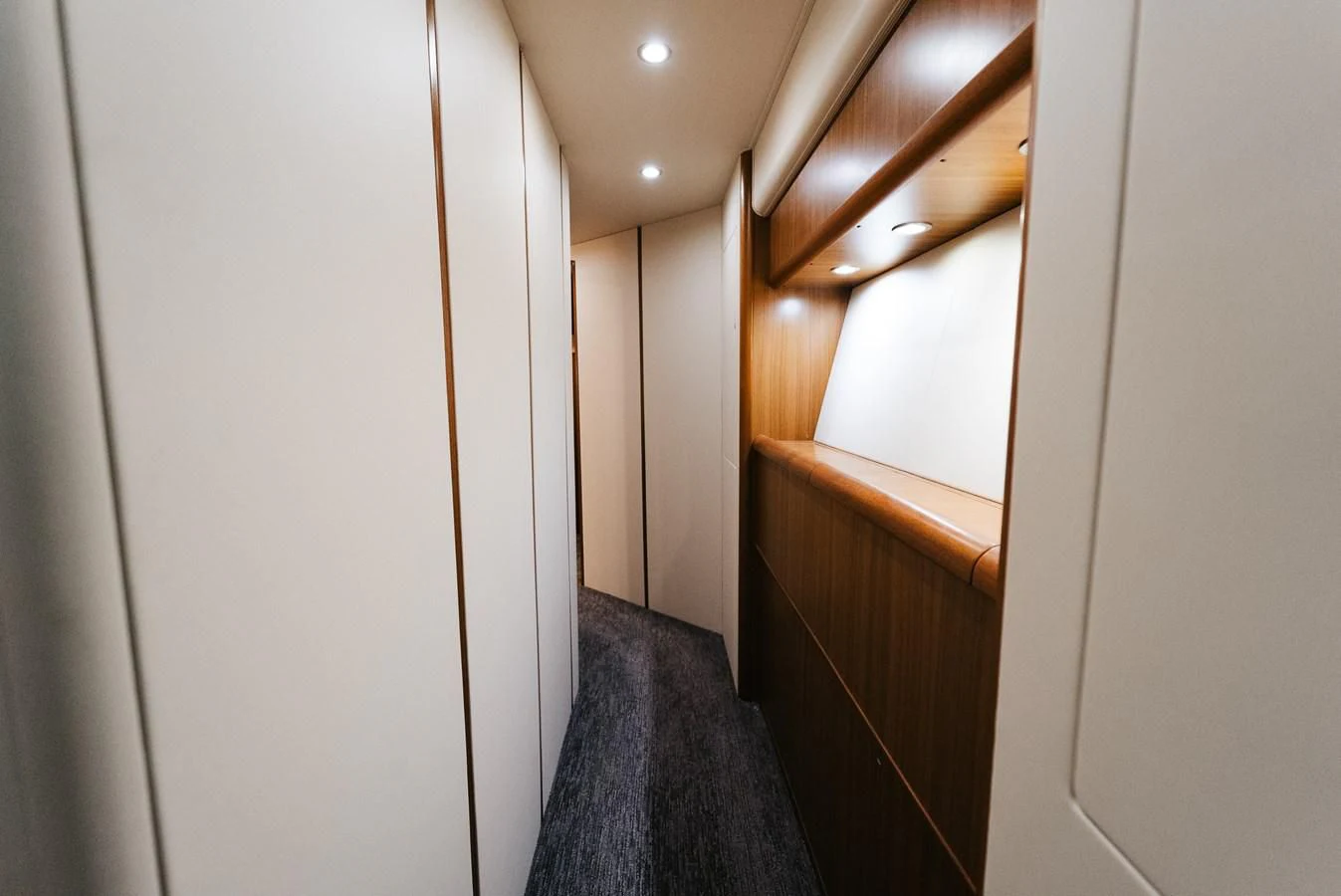 a hallway with a door and a light on the ceiling aboard RHINO FISH Yacht for Sale